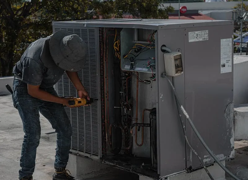HVAC technician performing maintenance on outdoor unit
